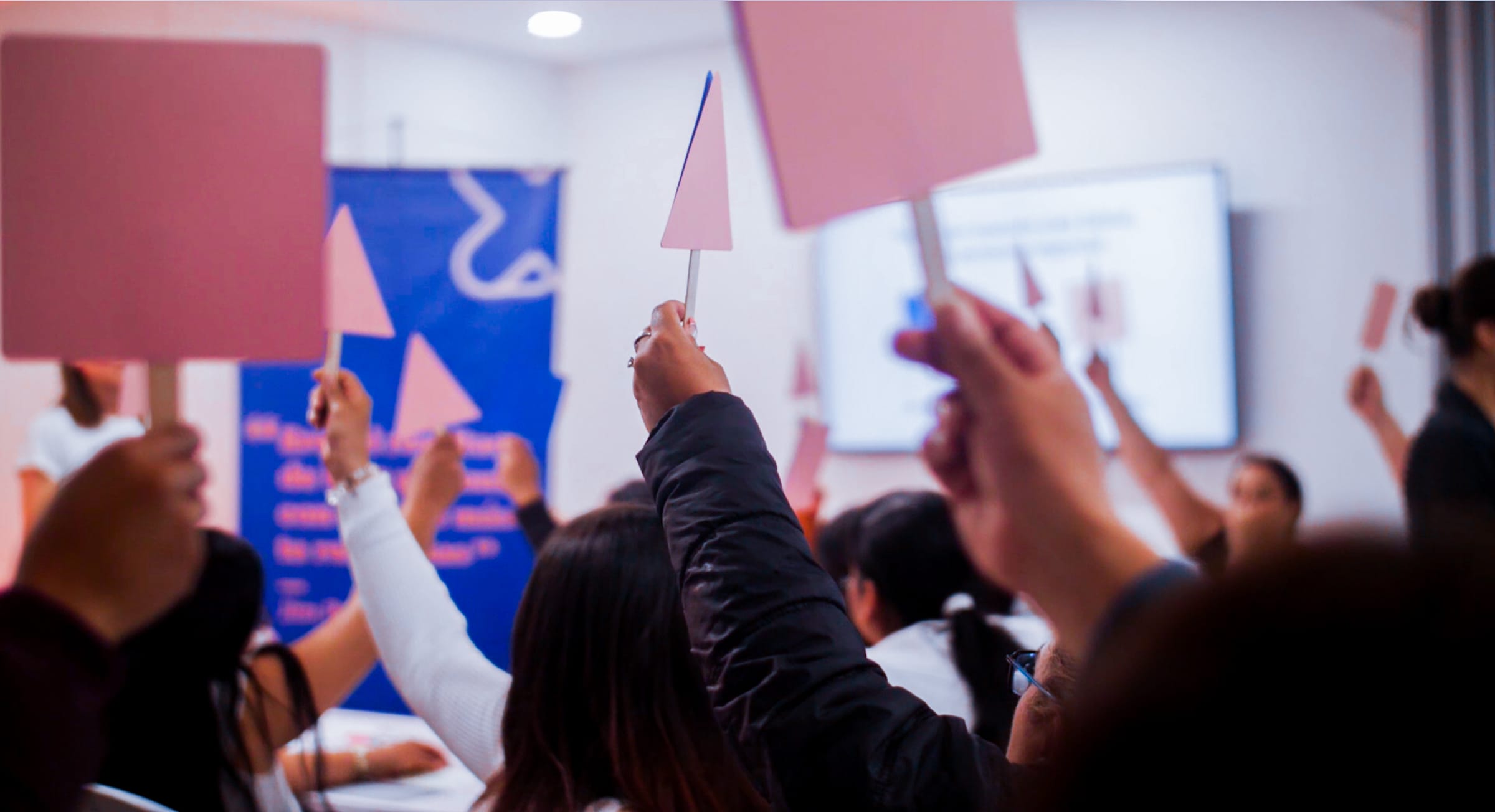 People voting with paddles.